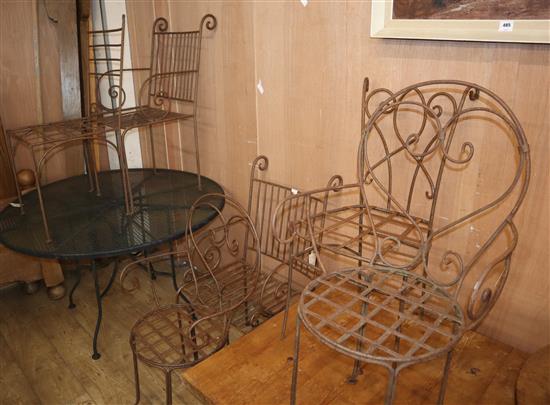Six wrought iron garden chairs and a circular metal table Diam.122cm